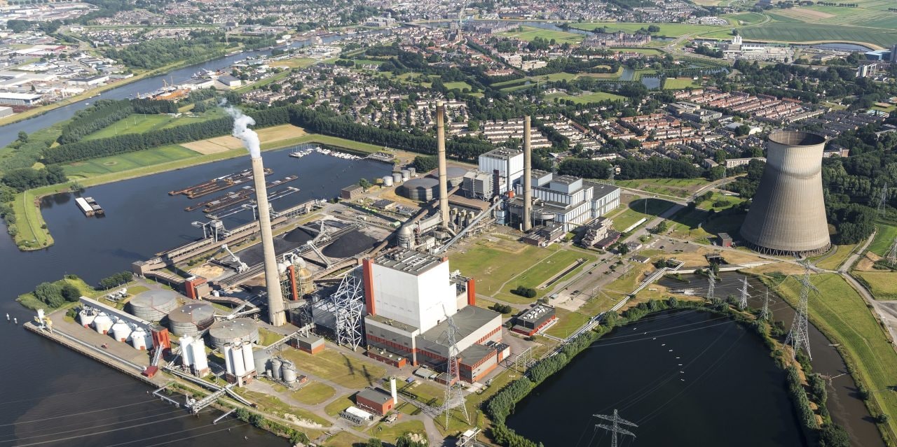 19 July 2016, Geertruidenberg, Holland. Aerial view of the AMERCENTRALE, a coal and biomass fired Essent powerplant. It's located at the river Amer. In the back the town of GEERTRUIDENBERG.