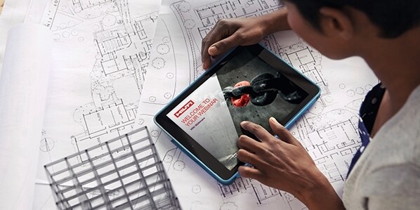 The modern architect Cropped shot of a young architect using her digital tablet to work on building plans