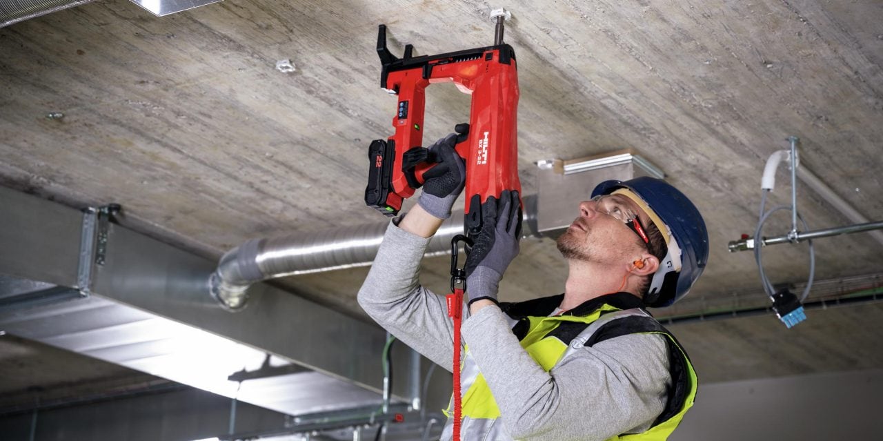 BX 3 battery-powered nailer, a virtually dust-free alternative to drilling, being used to fasten on concrete